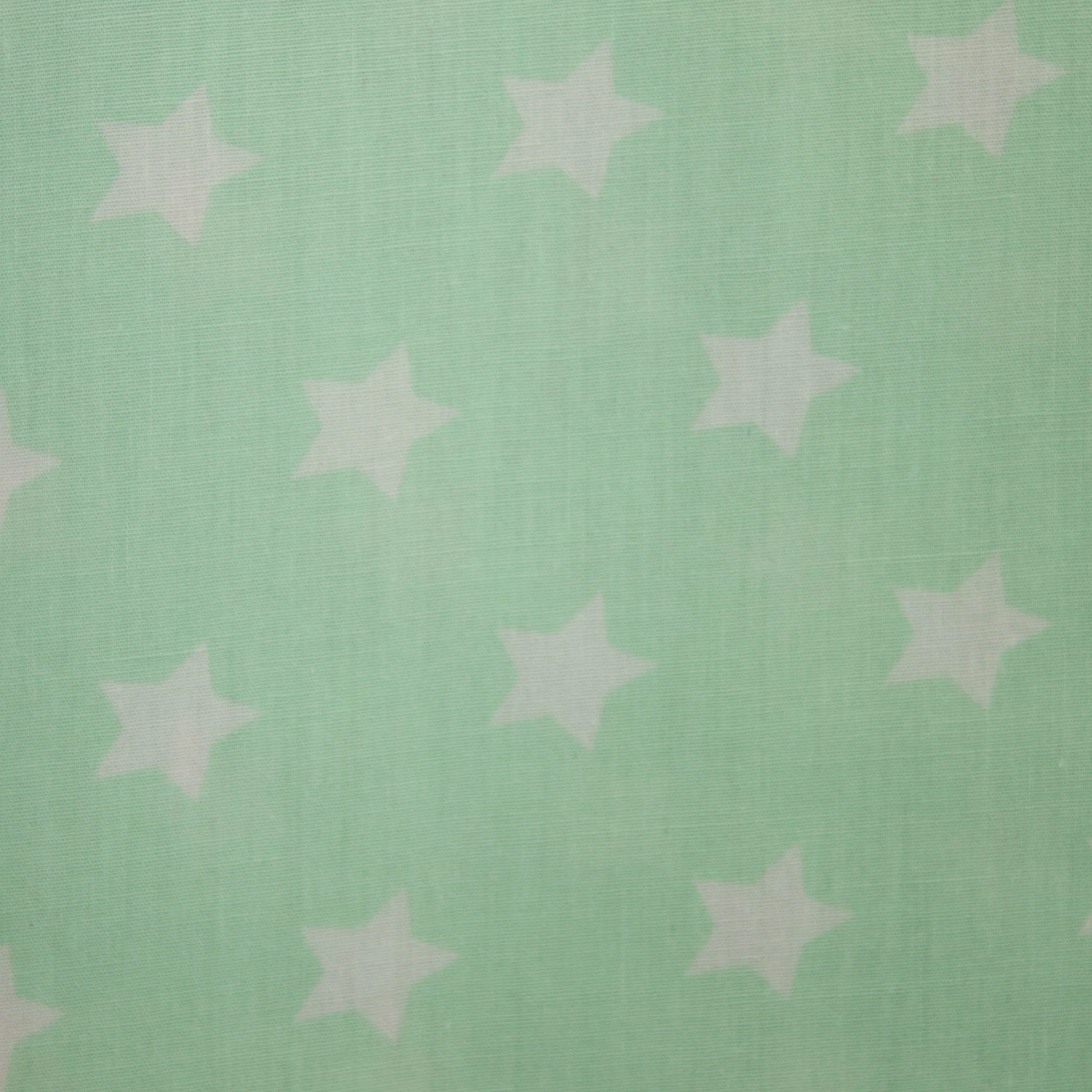 Katoen licht appelblauwzeegroen met kleine witte sterren